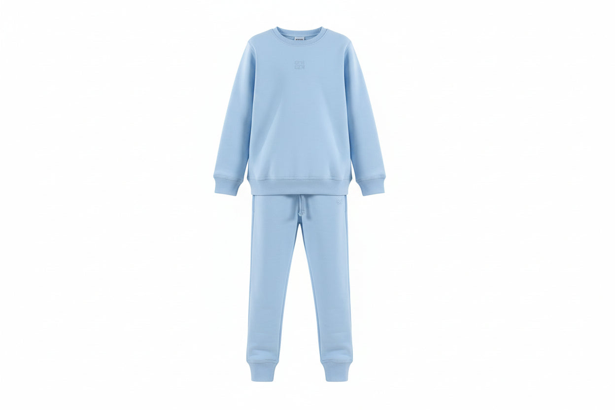 Child wearing a light blue pajama set on a white background