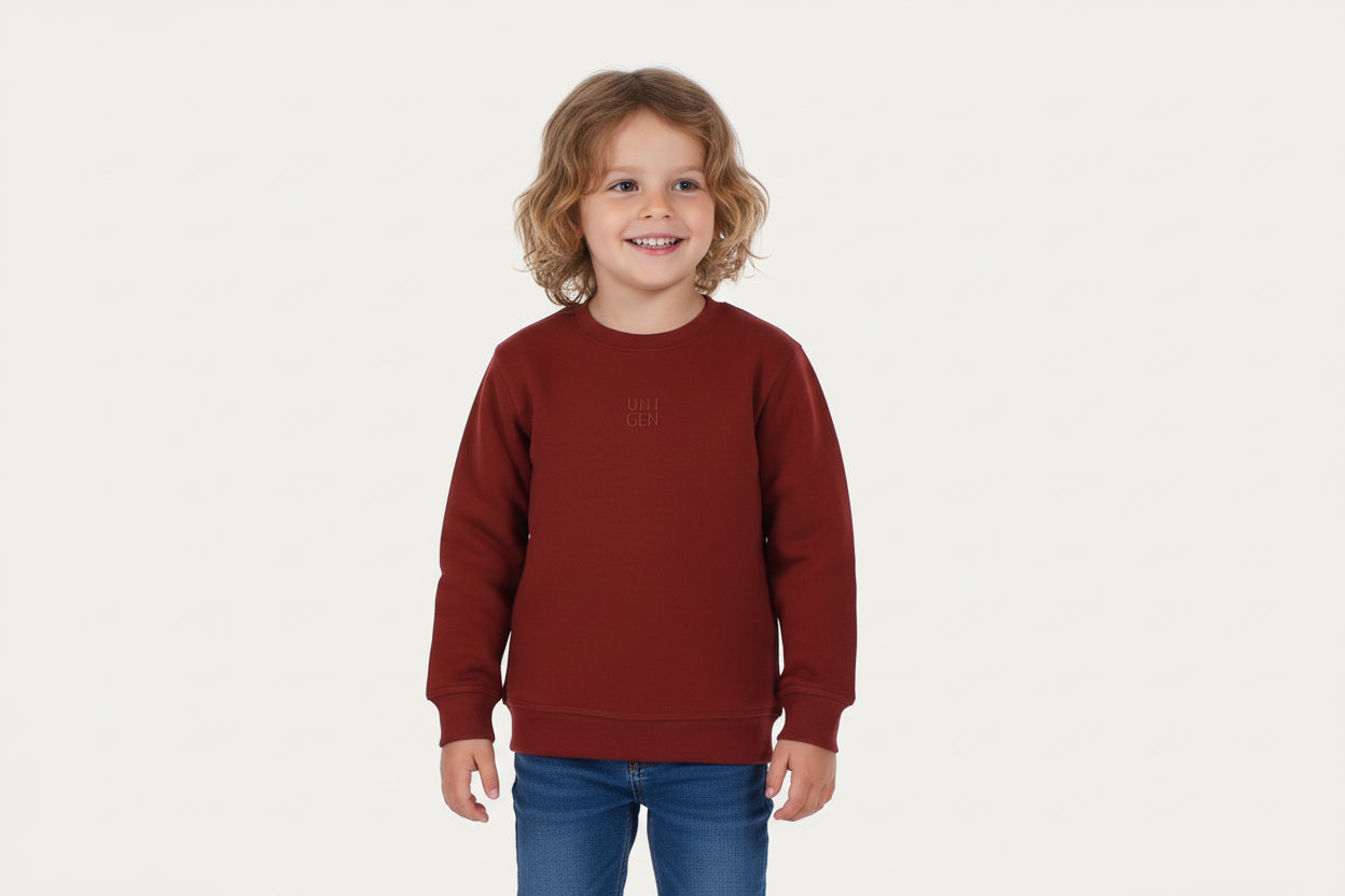 Child wearing a red sweatshirt with a logo on a white background